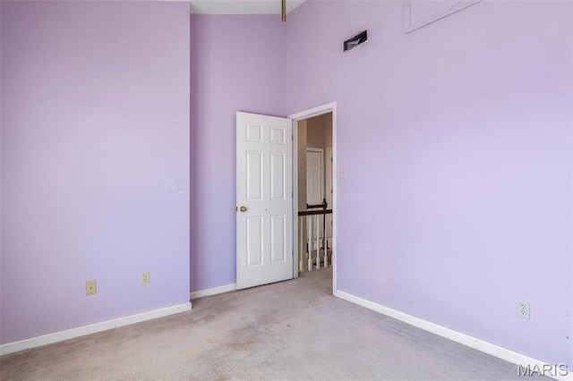 4645 Quail Run Rd, Farmington, MO 63640 - empty room with baseboards, carpet floors, a towering ceiling, and attic access