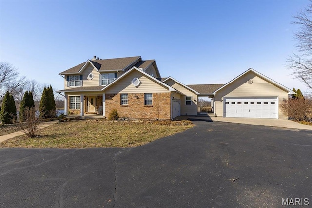 4645 Quail Run Rd, Farmington, MO 63640 - traditional-style home with asphalt driveway, a garage, brick siding, and covered porch