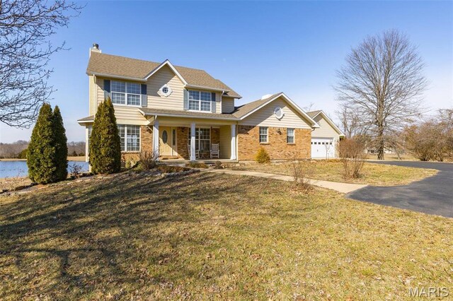 4645 Quail Run Rd, Farmington, MO 63640 - traditional-style house featuring covered porch, a chimney, a front lawn, and driveway