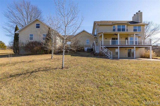 4645 Quail Run Rd, Farmington, MO 63640 - back of house with a ceiling fan, stairs, a chimney, a lawn, and a wooden deck