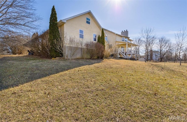 4645 Quail Run Rd, Farmington, MO 63640 - back of property featuring a yard, a chimney, covered porch, and stairs