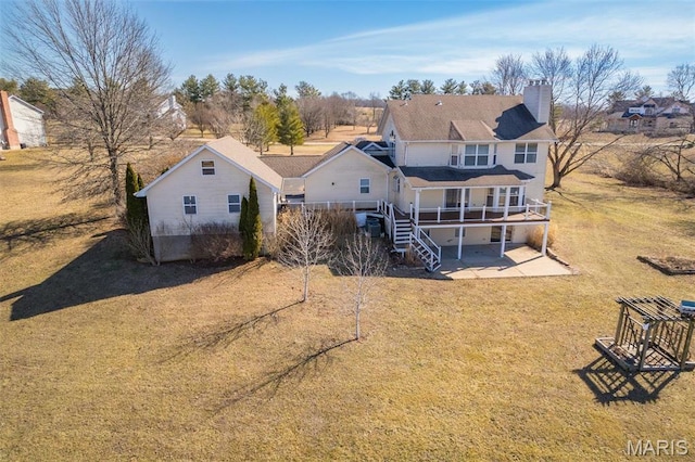 4645 Quail Run Rd, Farmington, MO 63640 - back of house featuring a chimney, a wooden deck, stairs, a lawn, and a patio