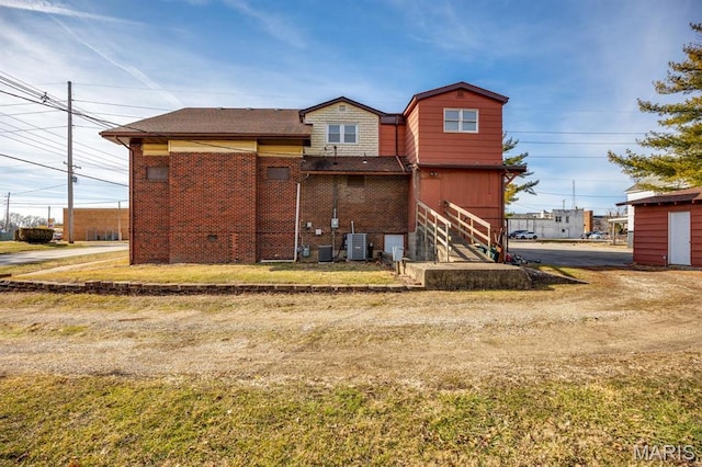 209 S Montgomery St, Gillespie, IL 62033 - rear view of house with brick siding and central AC