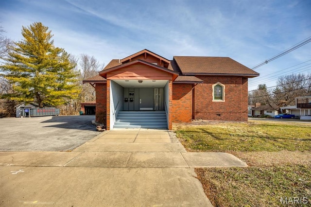 209 S Montgomery St, Gillespie, IL 62033 - view of front facade with brick siding, a front yard, crawl space, and roof with shingles