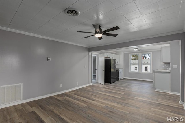 209 S Montgomery St, Gillespie, IL 62033 - unfurnished living room with a ceiling fan, ornamental molding, dark wood finished floors, and baseboards