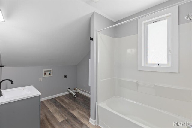 209 S Montgomery St, Gillespie, IL 62033 - full bath featuring wood finished floors, lofted ceiling, baseboards, shower / bath combination, and vanity