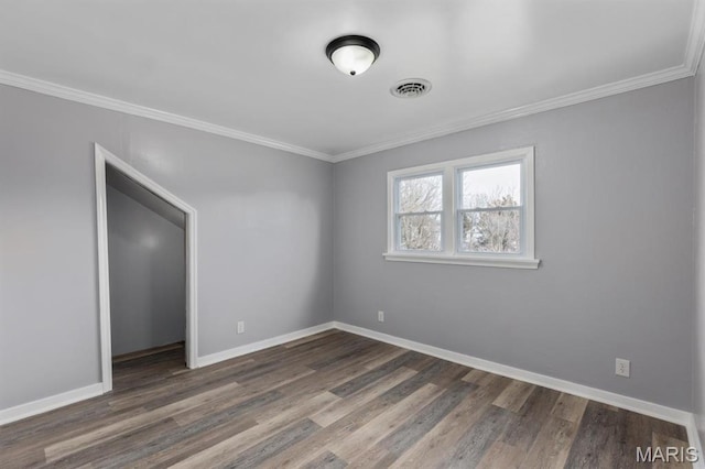 209 S Montgomery St, Gillespie, IL 62033 - spare room featuring ornamental molding, wood finished floors, and baseboards
