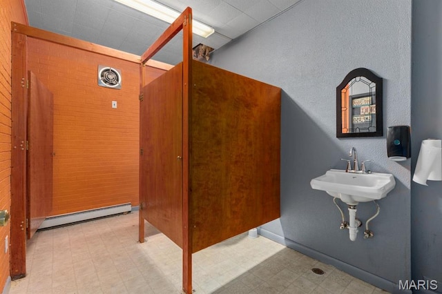 209 S Montgomery St, Gillespie, IL 62033 - bathroom with tile patterned floors, a baseboard heating unit, and wood walls