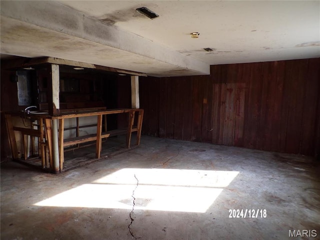 6045 Ozark Dr, High Ridge, MO 63049 - miscellaneous room with wood walls and unfinished concrete flooring