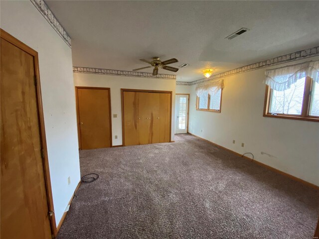 16340 Caldwell Ln, Dixon, MO 65459 - unfurnished bedroom with carpet flooring, multiple closets, and baseboards