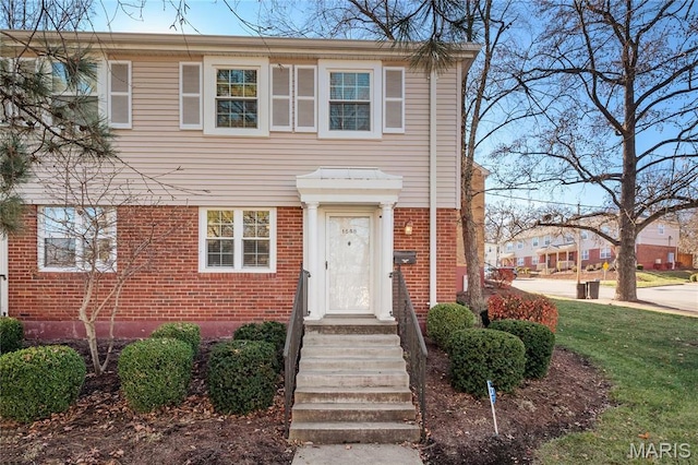 1508 Swallow Dr, Saint Louis, MO 63144 - view of front of house with brick siding and a front yard