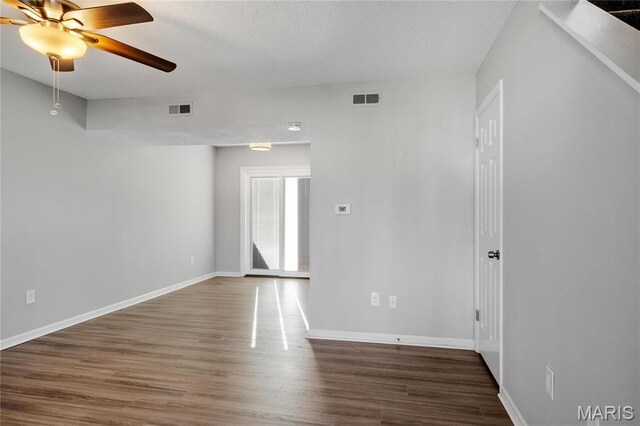 1508 Swallow Dr, Saint Louis, MO 63144 - unfurnished room featuring wood finished floors, a ceiling fan, baseboards, and a textured ceiling