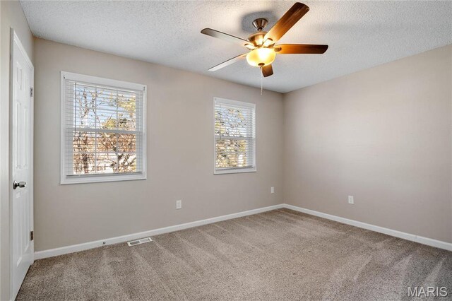 1508 Swallow Dr, Saint Louis, MO 63144 - carpeted empty room with a textured ceiling, a ceiling fan, and baseboards