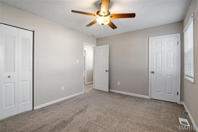 1508 Swallow Dr, Saint Louis, MO 63144 - unfurnished bedroom featuring carpet flooring, baseboards, a closet, a textured ceiling, and ceiling fan