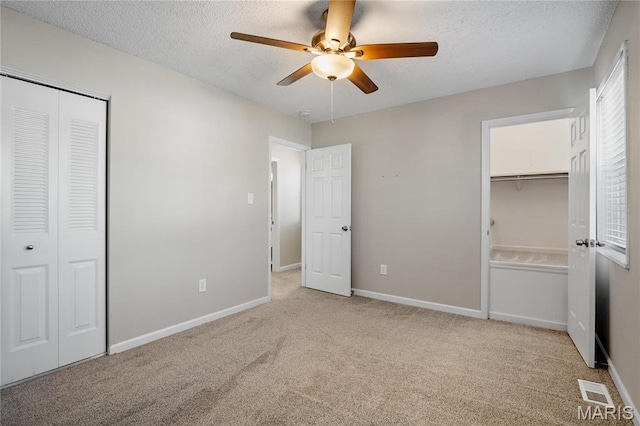 1508 Swallow Dr, Saint Louis, MO 63144 - unfurnished bedroom with light colored carpet, a textured ceiling, a closet, baseboards, and ceiling fan