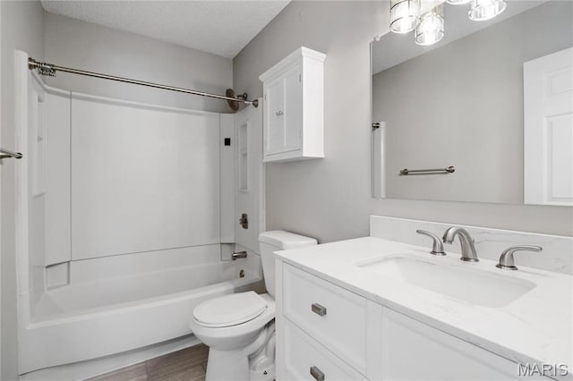 1508 Swallow Dr, Saint Louis, MO 63144 - full bath with toilet,  shower combination, vanity, wood finished floors, and a textured ceiling