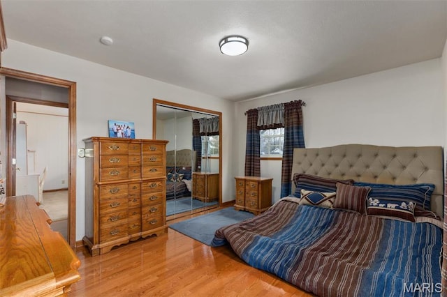807 W Miller Dr, Staunton, IL 62088 - bedroom featuring wood finished floors, a closet, and baseboards