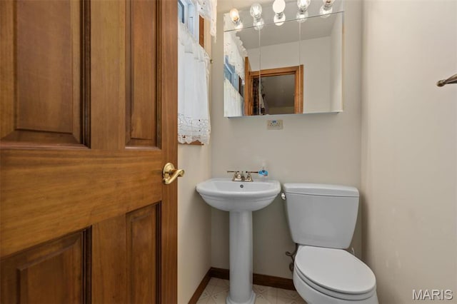807 W Miller Dr, Staunton, IL 62088 - bathroom featuring toilet, a sink, and baseboards