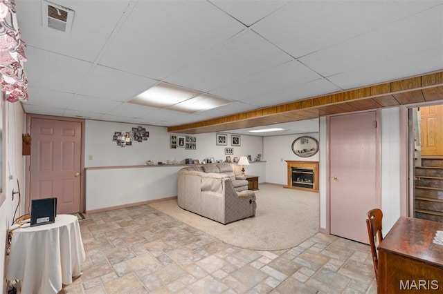 807 W Miller Dr, Staunton, IL 62088 - living area featuring stairs, a paneled ceiling, baseboards, light stone finish floors, and a fireplace
