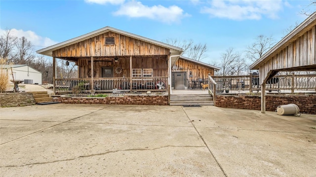 291 Deer Run Acres A, Williamsville, MO 63967 - rear view of house with covered porch, board and batten siding, and central AC