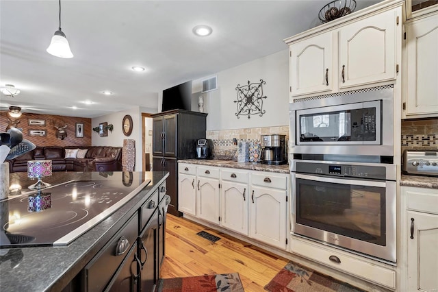 291 Deer Run Acres A, Williamsville, MO 63967 - kitchen with appliances with stainless steel finishes, backsplash, light wood-style floors, dark countertops, and recessed lighting