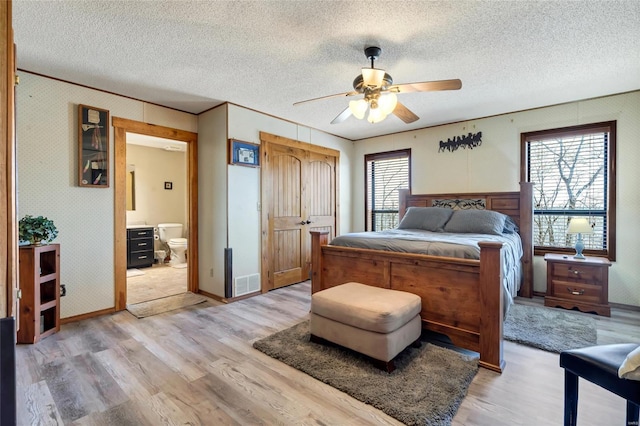 291 Deer Run Acres A, Williamsville, MO 63967 - bedroom featuring light wood-style floors, a textured ceiling, ensuite bathroom, and ceiling fan