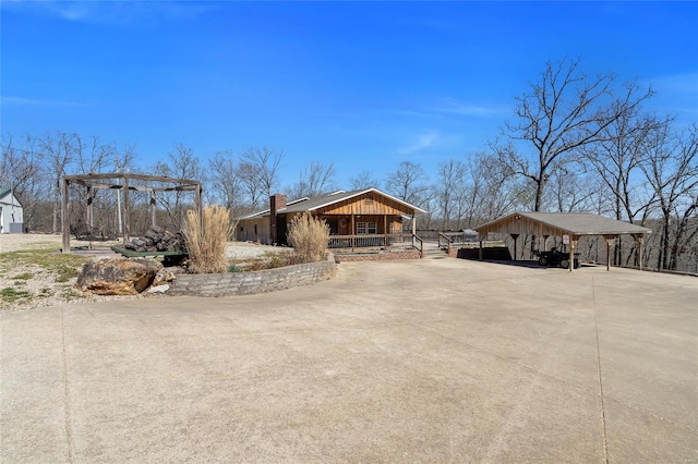 291 Deer Run Acres A, Williamsville, MO 63967 - view of front facade with a carport, board and batten siding, a porch, and concrete driveway