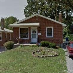 4707 Begg Blvd, Saint Louis, MO 63121 - bungalow featuring a front lawn, a chimney, and brick siding