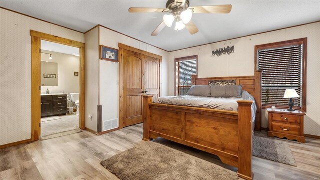 302 Deer Run Acres A, Williamsville, MO 63967 - bedroom with light wood-style flooring, ornamental molding, wallpapered walls, ensuite bathroom, and a ceiling fan