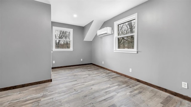 302 Deer Run Acres A, Williamsville, MO 63967 - additional living space featuring a wall unit AC, baseboards, and light wood-type flooring