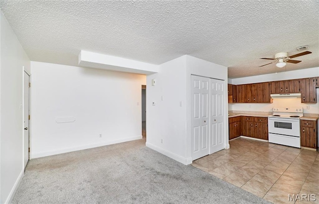 285 Mount Everest Dr, Fenton, MO 63026 - kitchen featuring electric stove, light countertops, under cabinet range hood, ceiling fan, and light carpet