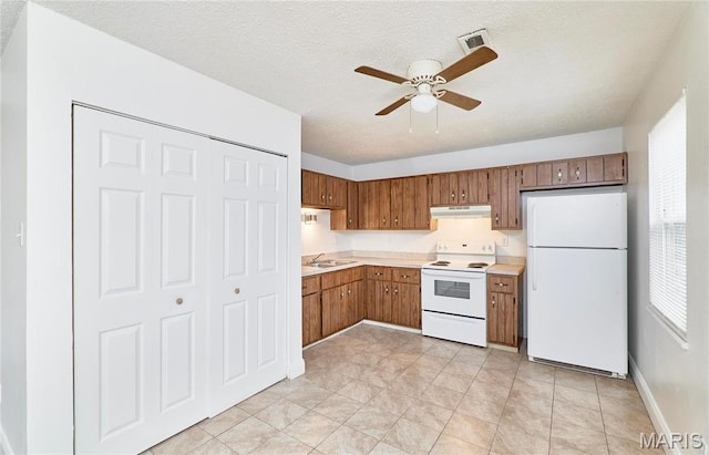 285 Mount Everest Dr, Fenton, MO 63026 - kitchen with white appliances, under cabinet range hood, a ceiling fan, plenty of natural light, and a textured ceiling