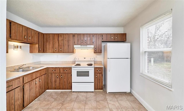 285 Mount Everest Dr, Fenton, MO 63026 - kitchen with white appliances, a sink, under cabinet range hood, light countertops, and brown cabinetry