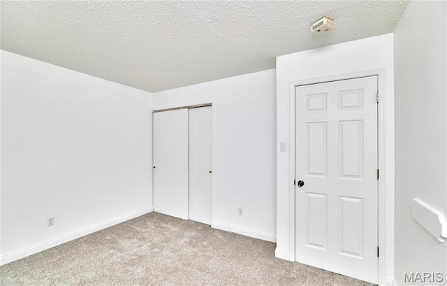 285 Mount Everest Dr, Fenton, MO 63026 - unfurnished bedroom featuring carpet, a closet, baseboards, and a textured ceiling