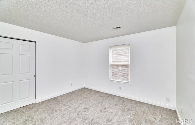 285 Mount Everest Dr, Fenton, MO 63026 - carpeted empty room with a textured ceiling and baseboards