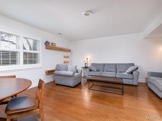 living room featuring light wood-type flooring and baseboards