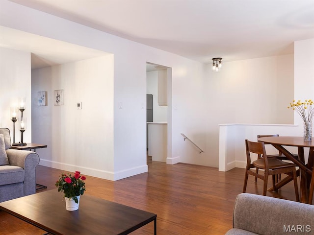 living area featuring wood finished floors and baseboards