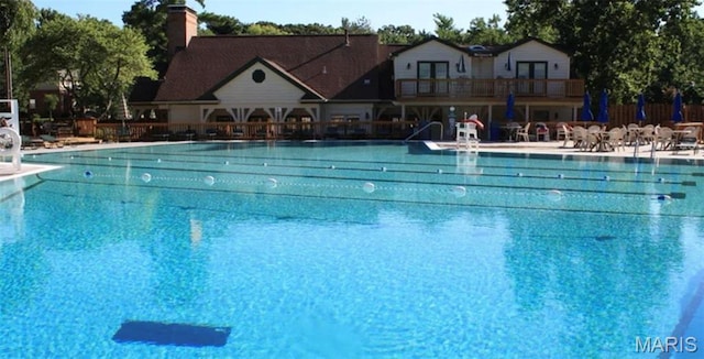 community pool with a patio area