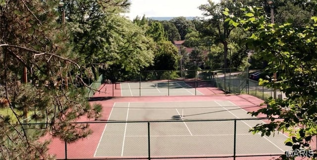 view of tennis court featuring fence