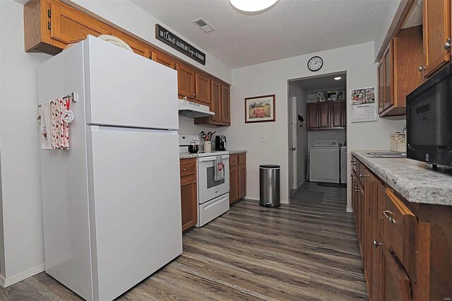 918 Susan St, Dexter, MO 63841 - kitchen featuring white appliances, under cabinet range hood, dark wood finished floors, light countertops, and a textured ceiling