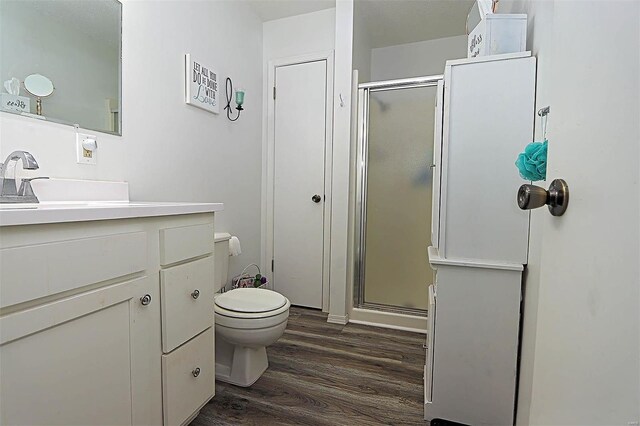 918 Susan St, Dexter, MO 63841 - bathroom featuring wood finished floors, a stall shower, vanity, and toilet