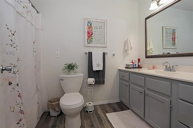 918 Susan St, Dexter, MO 63841 - bathroom with wood finished floors, vanity, toilet, and baseboards