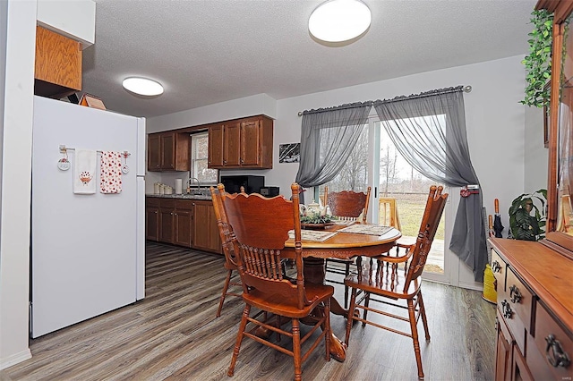 918 Susan St, Dexter, MO 63841 - dining room with wood finished floors, plenty of natural light, and a textured ceiling