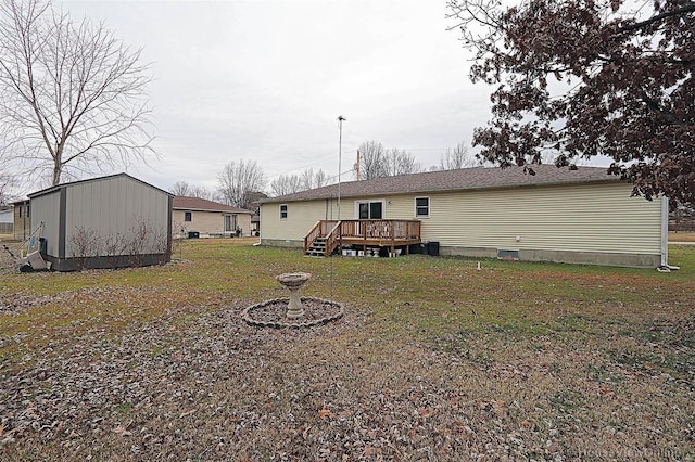 918 Susan St, Dexter, MO 63841 - back of house featuring a deck, a lawn, an outbuilding, and a storage shed