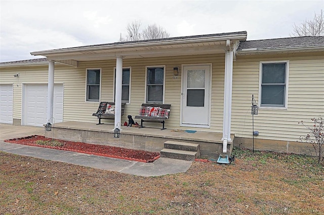 918 Susan St, Dexter, MO 63841 - view of front of house featuring covered porch, a garage, and concrete driveway