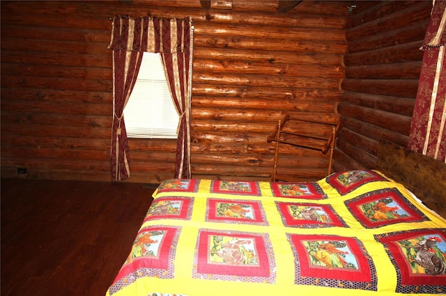 bedroom featuring rustic walls and dark wood-style floors