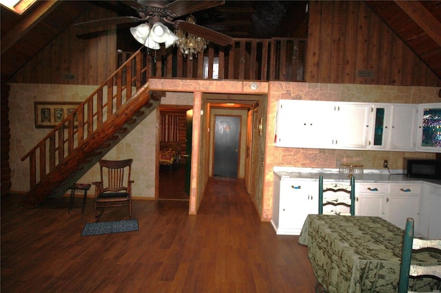 kitchen with black microwave, lofted ceiling, white cabinets, dark wood-style floors, and a ceiling fan