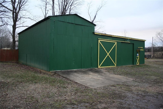 view of pole building with fence