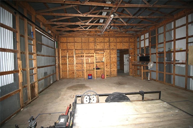 misc room featuring a garage and vaulted ceiling