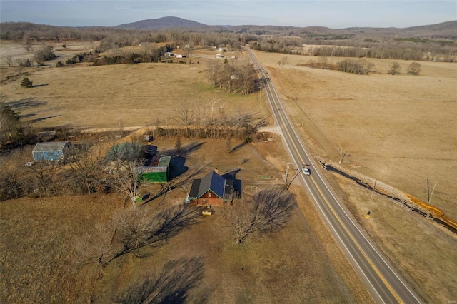 aerial view of property's location with rural landscape and a mountainous background